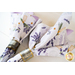 Two sided cloth napkins one side with purple fabric the other with white fabric featuring lavender prints.