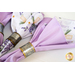 Two sided cloth napkins one side with purple fabric the other with white fabric featuring lavender prints.