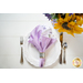 Two sided cloth napkin one side with purple fabric the other with white fabric featuring lavender prints.