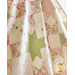 A quilt with geometric square and triangle designs made of pastel color fabrics on white draped over furniture.