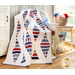 White quilt with diamonds made of strips of red white and blue patriotic fabrics.