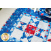 Geometric able runner made of patriotic summer themed fabrics in red, white, and blue.