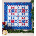 Geometric wall hanging made of patriotic summer themed fabrics in red, white, and blue.