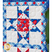 Geometric wall hanging made of patriotic summer themed fabrics in red, white, and blue.