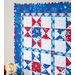 Geometric wall hanging made of patriotic summer themed fabrics in red, white, and blue.