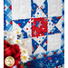 Geometric wall hanging made of patriotic summer themed fabrics in red, white, and blue.