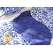Table runner with overlapping "S" curve design made of blue and white floral printed fabrics.