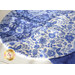 Table runner with overlapping "S" curve design made of blue and white floral printed fabrics.