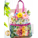 Tote bag made of strips of bright colorful floral printed fabrics filled with flowers.