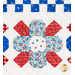 Row of geometric florals made of red white and blue fabric on white quilt.