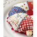 Round pin cushion made from triangle pieces of fabric with patriotic embroidery and a button middle.