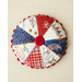 Round pin cushion made from triangle pieces of fabric with patriotic embroidery and a button middle.