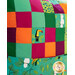 Colorful quilt patchwork featuring tropical motifs, including a toucan and various leaf patterns.