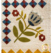 Appliqué quilt featuring a floral design with a blue tulip and red flowers, surrounded by patterned borders.