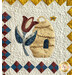 Quilted wall hanging featuring a flower and a bee house, surrounded by a checkerboard border.