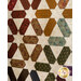 A colorful quilt featuring star-shaped patterns in various fabrics, set against a cream background.