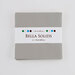 Solid gray Bella Solids charm pack isolated on a white background