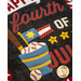 A close-up of a decorative fabric featuring the phrase Happy Fourth of July alongside images of a bucket filled with baseballs, a small flag, and stars, all on a dark background.