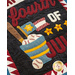 A decorative textile featuring the phrase fourth of July in red and blue letters, accompanied by an illustration of a blue bucket filled with baseballs, a bat resting beside it, and star shapes in yellow. The background includes a patchwork design with red and white triangles.