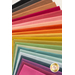 A variety of colorful sheets of paper arranged in a layered fashion, showcasing a spectrum of colors including pinks, yellows, greens, and blues.