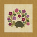 A green turtle surrounded by colorful flowers on a textured beige background.