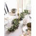 A sage leaf felt centerpiece set on a modern table