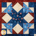 Stars and stripes quilt made of geometric blocks featuring red, blue, and cream, patriotic fabric prints.