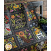 An image of a Simple Blessings BOM Quilt draped on a bench.