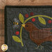 A close up image of a bird, bumble bee, and a vine in the corner of a Simple Blessings BOM Quilt.