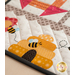 Table runner featuring geometric squares along with bee and floral appliqué on each end.