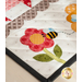 Table runner featuring geometric squares along with bee and floral appliqué on each end.