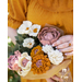 Flowers made of fabric being held as a bouquet.