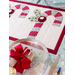 Red and white table runner featuring 3 candy canes with fabric yo-yos, all made of Winter themed fabric prints.