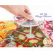 A hand holds a transparent template labeled Mirror Angle Holder above a vibrant, floral-patterned fabric. Text to the side reads GET the Magic Mirrors.