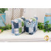 Two small bags with hanging charms and patchwork design made of blue, green, and white summer themed fabrics on a white countertop