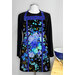 Vibrant blue and black floral apron displayed on a mannequin, paired with a black long-sleeve shirt.