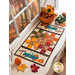 Table runner with square and triangle design with autumn themed fabrics and a truck with pumpkins appliqué on the ends.