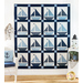 Quilt featuring blocks of geometric sail boats made of white and blue fabrics.
