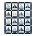 Quilt featuring blocks of geometric sail boats made of white and blue fabrics.