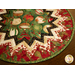 Folded star table topper with lovely Christmas prints in red, green, and white.