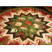 Folded star table topper with lovely Christmas prints in red, green, and white.