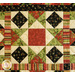 Patchwork quilt featuring a central red square surrounded by green and black geometric patterns with floral accents.