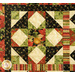 A colorful quilt featuring floral patterns, diamond shapes, and striped sections in red, green, and black.