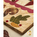 Pint Size Table Runner featuring leaf like geometric piecing and squirrel and leaf appliqué.