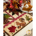 Pint Size Table Runner featuring leaf like geometric piecing and squirrel and leaf appliqué.