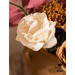 Close up of gold and white paper flowers in a clay vase.