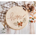 Embroidery hoop with hand embroidery featuring florals and the word home.