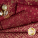 Some of the fabrics included in the red/gold set, with metallic gold details on deep wine red fabrics.