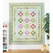 Quilt filled with sawtooth stars and flower appliqué in pastel green and purple colors.