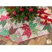 Tree skirt with patchwork and geometric star design made of red, white, and green, Christmas themed fabrics.